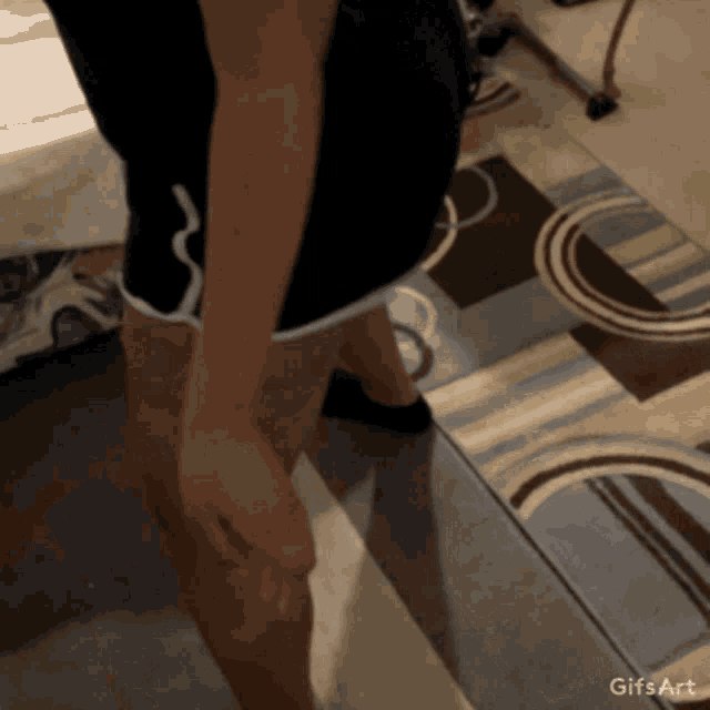 a gif of a person standing on a rug with the words gifs art below it
