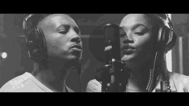 a man and a woman are singing into microphones