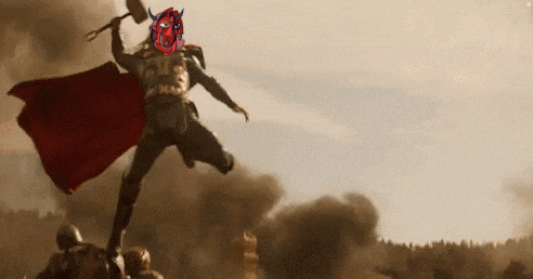 thor is holding a hammer in his hand and wearing a red cape in a battle scene .