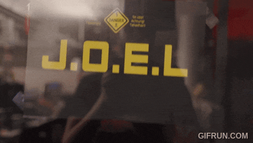 a sign that says j.o.e.l on it in yellow letters