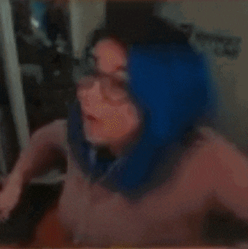 a blurry picture of a person 's face with a yellow and blue background