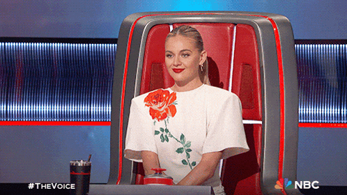 a woman is sitting in a chair with a nbc logo on the bottom