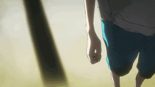 a person in blue shorts and a white shirt is walking on a sandy surface