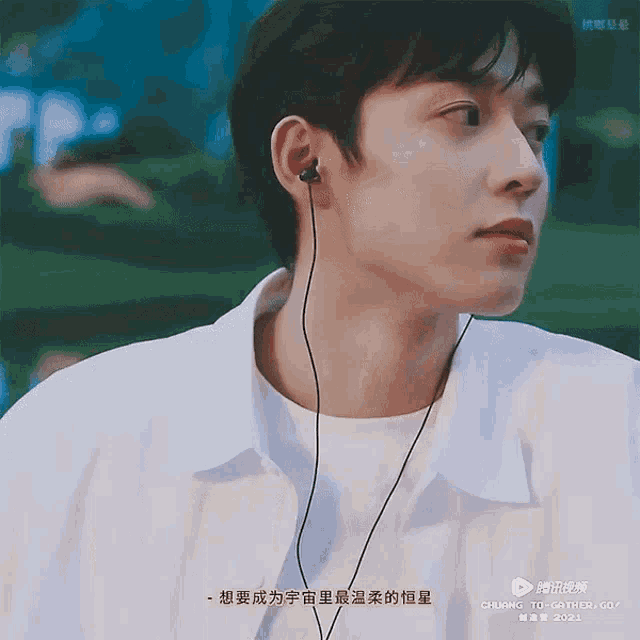 a close up of a man wearing headphones with chinese writing on the bottom