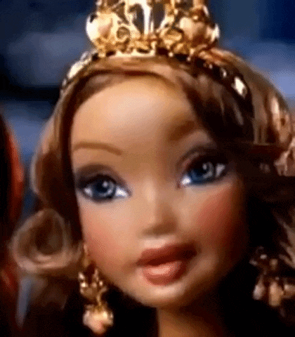 a close up of a barbie doll wearing a tiara and earrings .