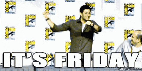 a man is dancing in front of a wall that says comic con on it .