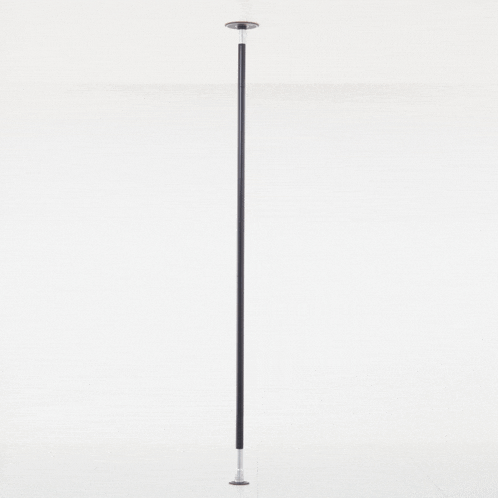 a black pole is against a white wall and has a stainless steel base