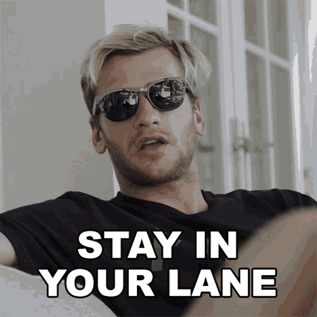 a man wearing sunglasses has the words stay in your lane above him