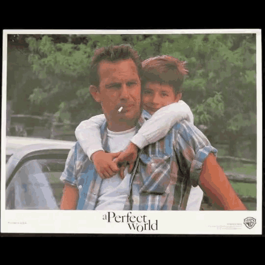 a movie poster for a perfect world shows a man smoking a cigarette while holding a child