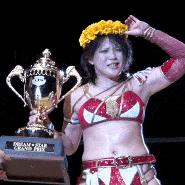 a woman holds a trophy that says dream star grand prix