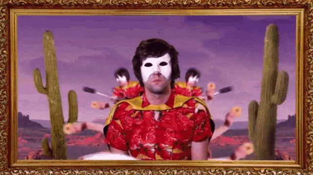 a framed picture of a man in a red shirt with a white mask