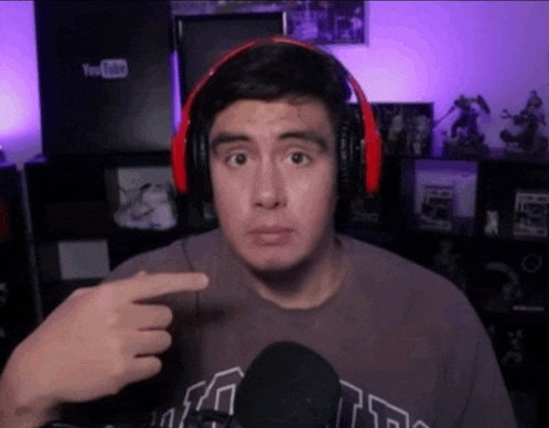 a man wearing headphones points to a youtube logo