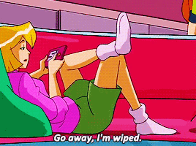 a cartoon girl is laying on a couch playing a video game and saying go away , i 'm wiped