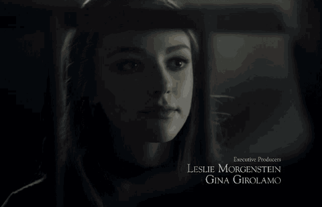 a close up of a woman 's face with the name leslie morgenstein gina girolamo below her