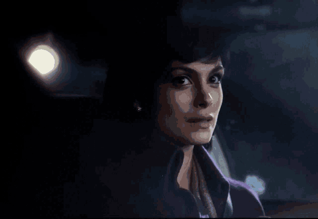 a woman in a purple coat is sitting in a car