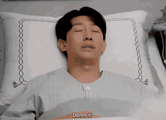 a man is laying in a hospital bed and says " damn it "