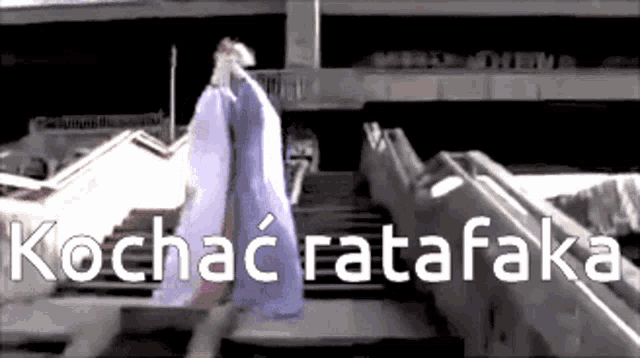 a person walking down a set of stairs with the words kochac ratafaka written on the bottom