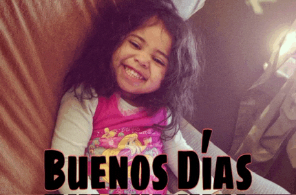 a little girl is smiling with the words buenos dias written below her