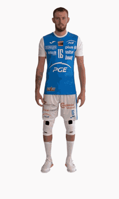a man wearing a blue and white pge jersey and shorts