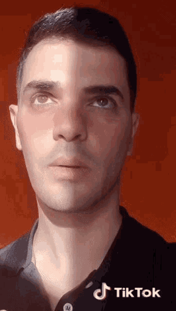 a close up of a man 's face with tiktok written on the bottom right