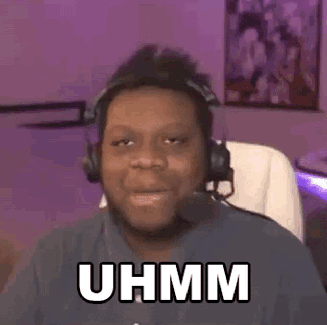 a man wearing headphones and a microphone is making a funny face .