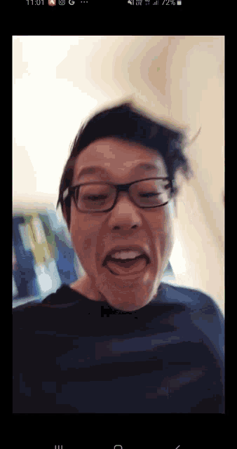 a man with glasses is making a funny face