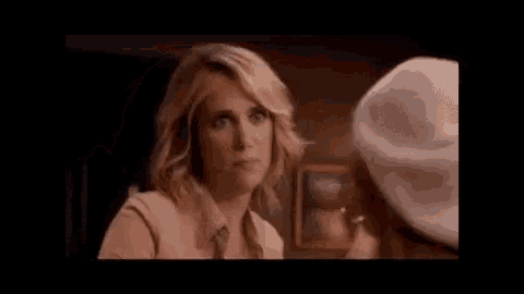 a woman with her mouth open is talking to another woman in a room .