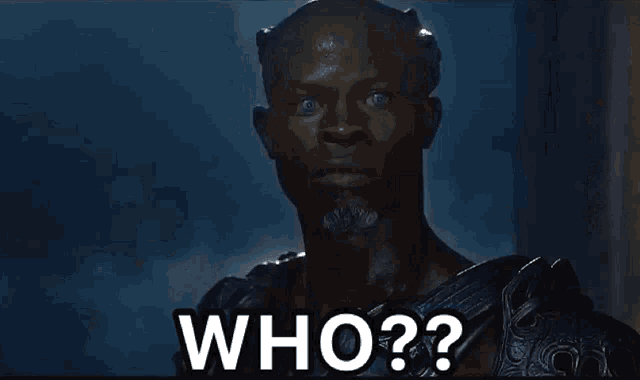 a man in armor is holding a shield and asking who
