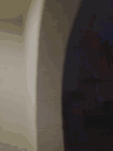 a close up of a person standing in a bathtub with a black shirt on .