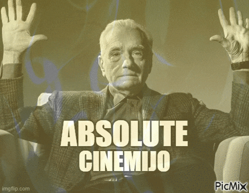 a man sitting in a chair with his hands in the air and the words absolute cinemijo