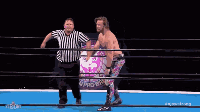 a wrestler named david finlay is standing in a ring