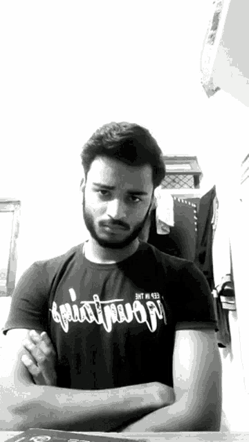 a man with a beard is wearing a black shirt that says ' squat mojo ' on it