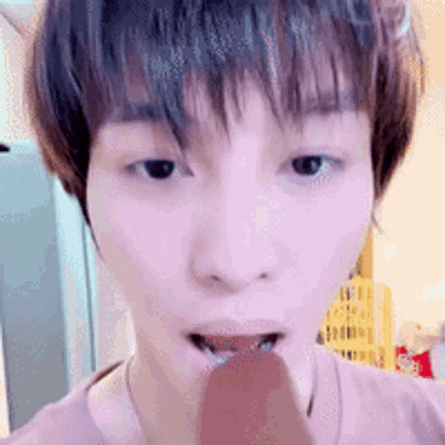 a close up of a person eating an ice cream