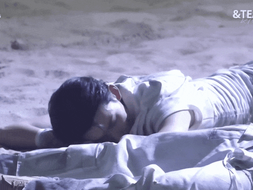 a person laying on a bed with the word te on the bottom