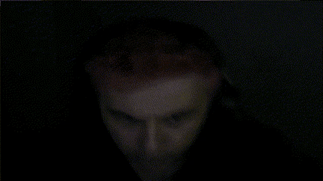a blurry picture of a person 's face with a dark background