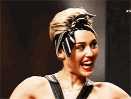 a close up of a woman wearing a headband and a necklace
