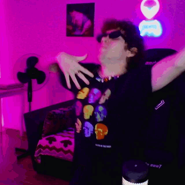 a man in a black shirt with skulls on it is dancing