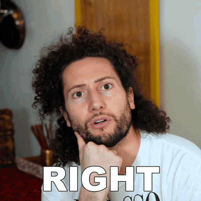 a man with curly hair and a beard is wearing a white shirt with the word right on it