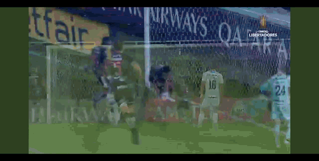a soccer game is being played in front of an ad for airways
