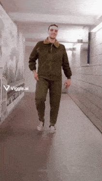 a man is walking down a hallway with a sign that says viggle.ai on the bottom