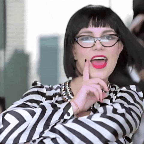 a woman wearing glasses and a striped shirt