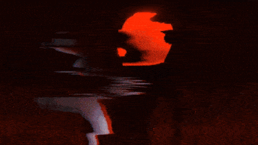 a girl with long white hair is standing in a dark room and looking at the camera .