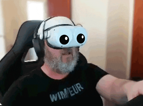 a man with a beard wearing a virtual reality headset and a shirt that says wimeur