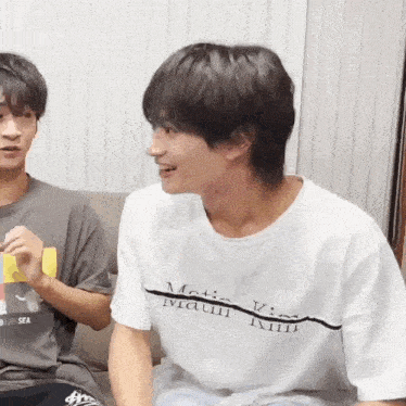 a man wearing a white t-shirt that says magic king