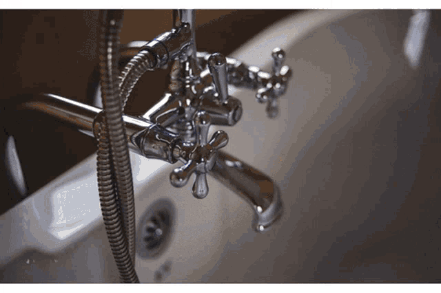 a close up of a bathtub with a chrome faucet