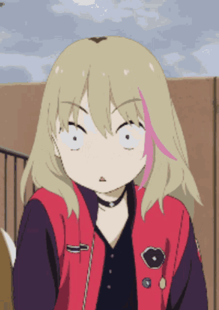 a girl with blonde hair is wearing a red jacket and making a funny face .