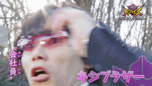 a man wearing sunglasses holds his hand to his forehead with chinese writing behind him