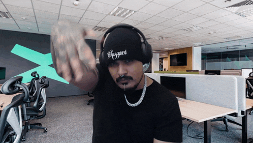 a man wearing headphones and a beeyard hat