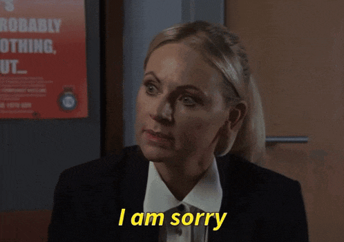 a woman says i am sorry in front of a poster that says probably nothing out