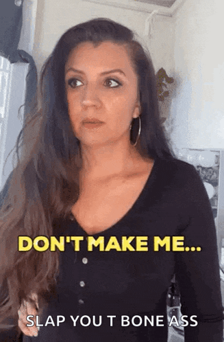 a woman with long hair is standing in front of a refrigerator and says don 't make me slap you t bone ass